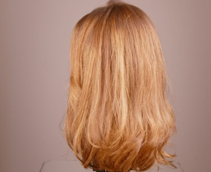 a blond woman's wig from behind